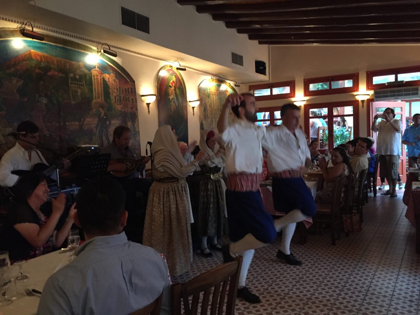 A group of people dancing in a restaurant.