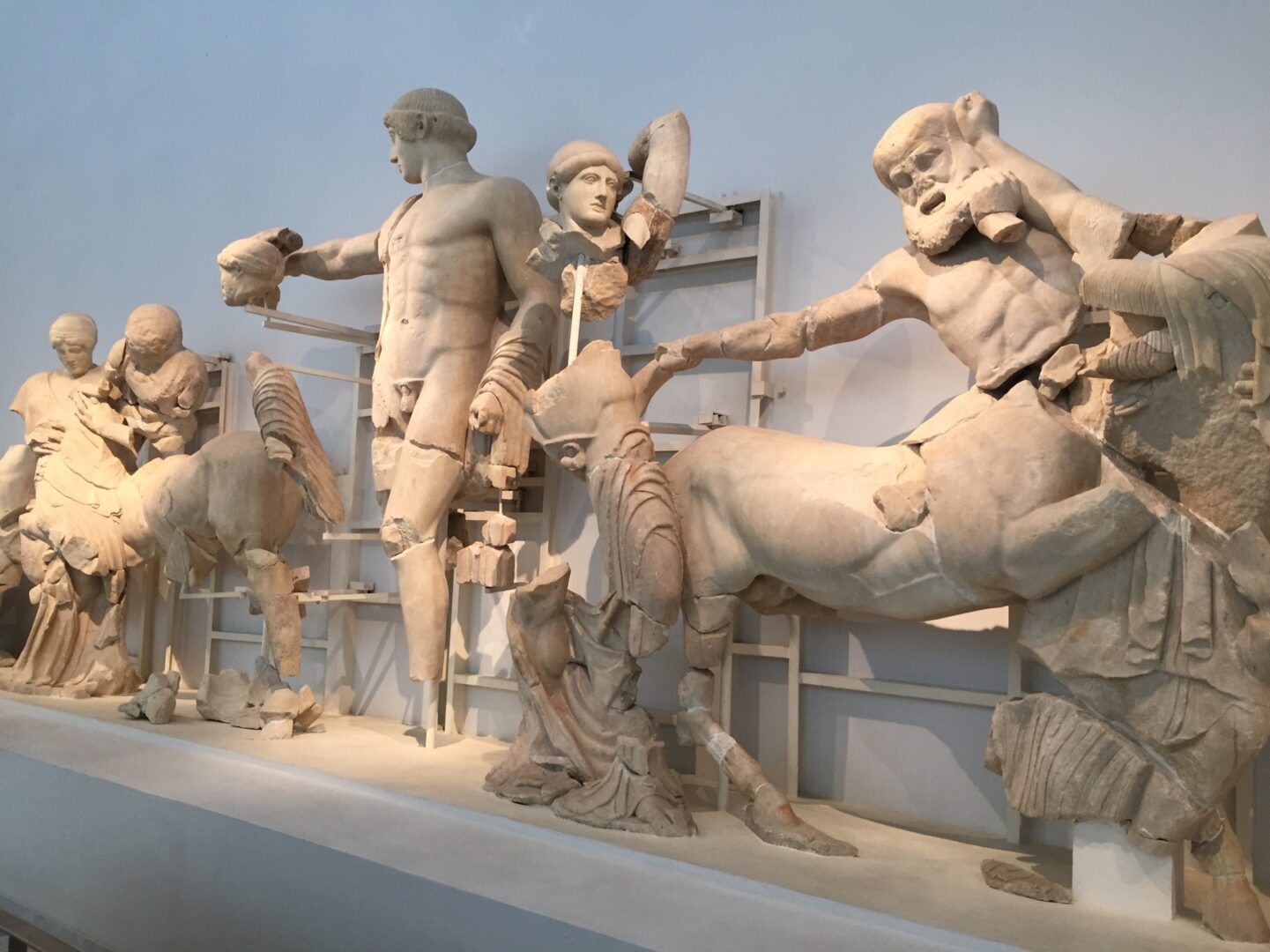 A group of statues on display in a museum.