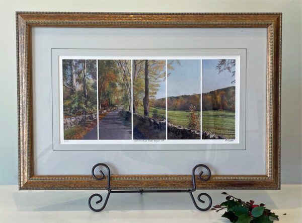 A framed print of four landscapes in a frame.