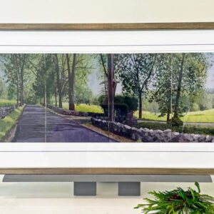 A framed painting of a road with trees in the background.