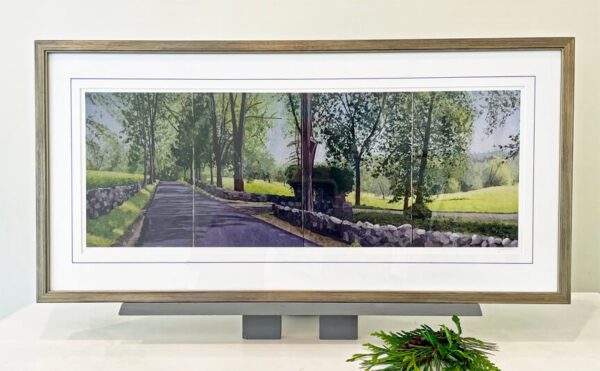 A framed painting of a road with trees in the background.