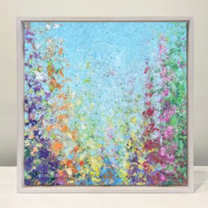 A painting of colorful flowers in a white frame.
