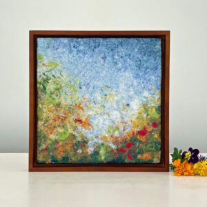 A framed painting with flowers on it.