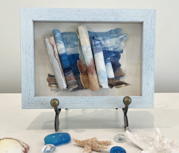 A blue frame with sea shells and a starfish.