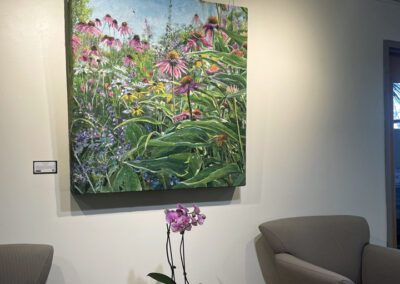A painting of flowers hanging on a wall.