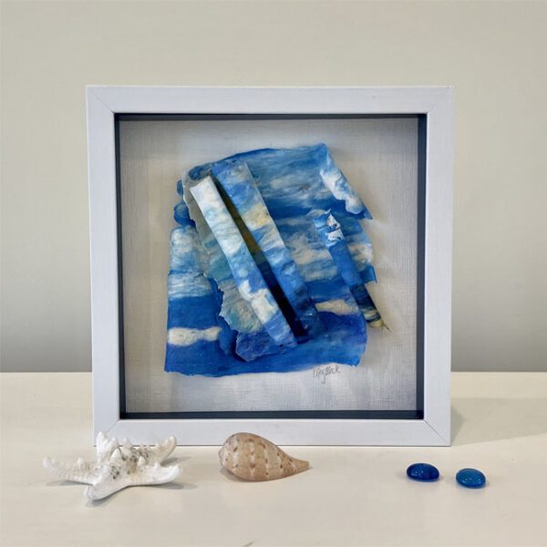 A Surf's Up II, 9 x 9 x 1 inches, blue shadow box and a starfish on a table.