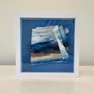 A blue and white frame with a piece of paper on it.