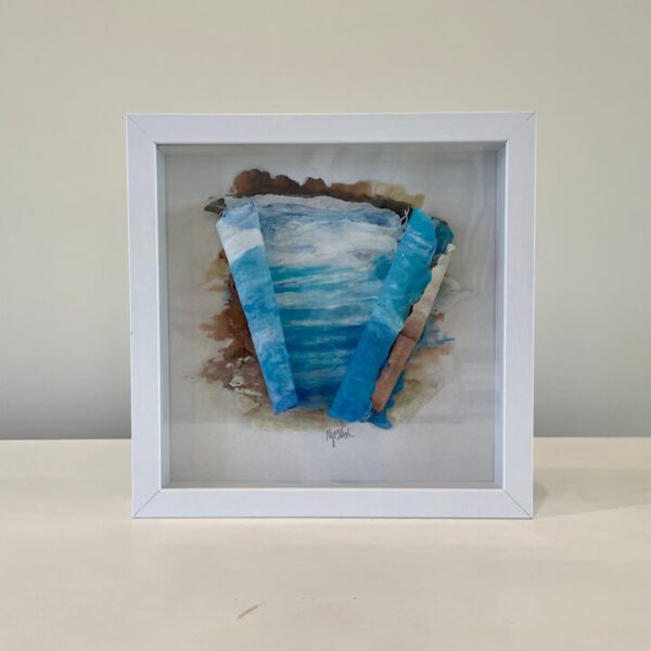 A white frame with a blue and white painting on it.