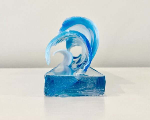 A sculpture of The Great Wave, epoxy, abaca, and pigment, 16 x 4 x 3-5 inches on a white surface.