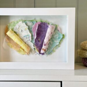 Letters to Theo, 7 x 5 x 1 inches, white shadow box frame displayed on a shelf beside colorful folded towels.