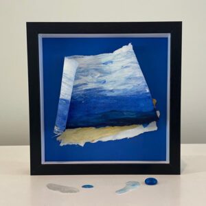 Abstract framed artwork with blue and white hues.