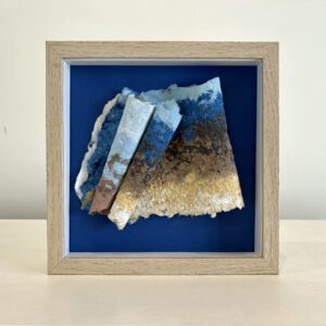 Beach combing, blue mat, maple shadow box frame, 9 x 9 x 2 inches